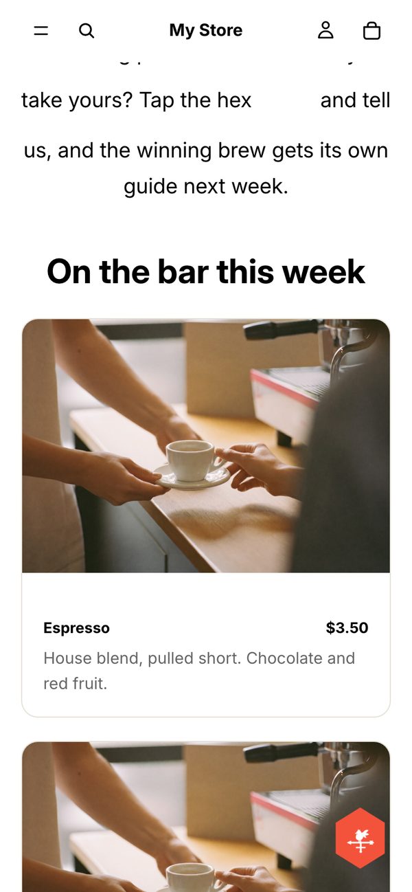 The Shopify test store on a phone after scrolling to the menu: the floating hex in the bottom-right corner of the screen
